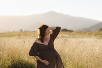 maternity session in a field with mountains in Christchurch