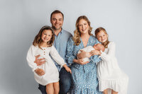 Newborn Pictures in Charleston - Infant posed with his family during Newborn Pictures at Holy City Babies Newborn Photography Studio in Charleston, SC.