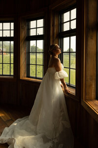 Bride looking out the window at a wedding in Vermont