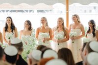 bridesmaids looking at bride