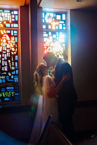 Husband and wife embrace in church after ceremony during Knoxville wedding