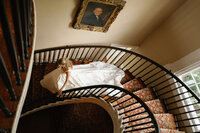 A bride going down the stairs at the Thomas Bennett House wedding in Charleston, SC