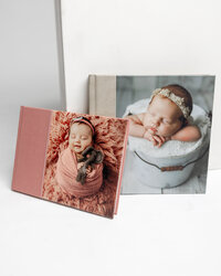 Luxury newborn photo albums featuring sleeping babies in soft wraps and neutral tones, Kaitlyn Dawn Photography, Yucaipa newborn photographer.