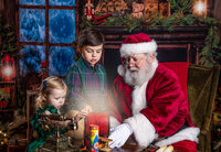 Children gathered around a glowing magical lantern with Santa during a Santa’s Magical Christmas photography session in Jacksonville, Florida with Nature’s Child Photography, cozy holiday decor and warm candlelight creating a storybook Christmas scene.
