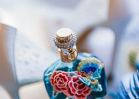 Detail shot of ring, perfume and bridal shoes at Loco Lake Event Venue captured by Graceful Ray Photography in Fort Worth Texas