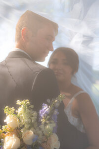 bride and groom smiling through veil garden wedding at rainbow oaks ranch in sanger california