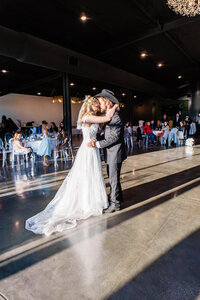 Bride and Groom sharing an emotional first dance at Loco Lake Event Venue captured by Graceful Ray Photography in Fort Worth Texas