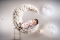 4Karma Studio - A creative fine art newborn portrait in Los Angeles featuring a baby sleeping on a crescent moon composite with whimsical styling and true-to-life colors.