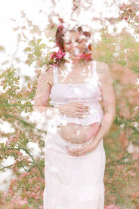 double exposure of mom holding pregnant belly and spring pink flowers in peoria il maternity photos