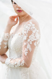 Soft and delicate lace wedding dress detail captured in wedding photography in Detroit