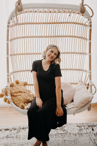Founder Dana sitting on a hanging chair