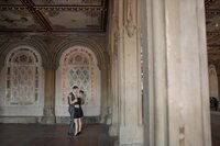 Central park engagement photos, Deborah Zoe Photography. A couple dance under archway in Central Park.