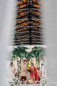 Couple dressed in traditional attire at a lavish wedding ceremony.