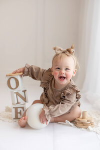Happy baby girl during her milestone session with Jennifer Brandes Photography near Mankato, Minnesota.