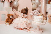 Charleston Cake Smash Photographer- Baby looks into the camera during Cake Smash Photos at Holy City Babies Portrait Studio in Charleston, SC.