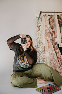 Morgan, owner of Orange Rose Photography, taking a photo on her camera