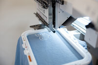 Close-up of embroidery machine stitching a design onto fabric. Photograph by Yucaipa branding photographer Kaitlyn Dawn Photography.
