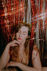 Flash portrait of Morgan Wright with a disco-inspired red and silver backdrop.
