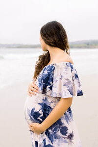 A mother holds her belly blose during her maternity photos in Carmel