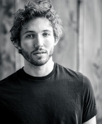 Close-up black and white image of a tech start-up executive looking serious