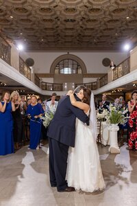first dance bride hugging father while dancing in detroit