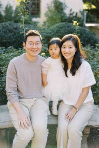 Family of three embracing in golden hour light, Silicon Valley family portraits
