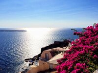 View from Greek cliff with white buildings overlooking the sea