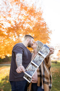 Man and woman posing for maternity photography in Milford mI