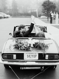 Newly married couple drives away at their Cleveland wedding
