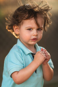 Toddler portrait with wind in hair in natural outdoor light in Eastern North Carolina