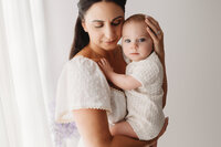 Charleston Motherhood Photographer - Mother poses with her baby during studio Mother's Day Mini Sessions at Holy City Babies Portrait Studio in Charleston, SC.