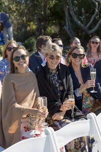 Guests smile at camera during wedding ceremony on Nantucket.