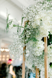Enchanting view of the flowery decorations hanging at the ceremony, creating a dreamlike and romantic atmosphere for the special occasion