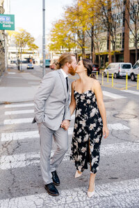 Pittsburgh couple kissing while walking in downtown Pittsburgh by Marien J. Malloy