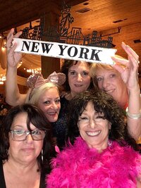 Family photo holding up New York sign in photo booth