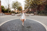 Tennessee graduating senior sprays champagne on campus during golden hour