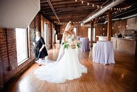 Mahlia helping the bride with her veil inside of Cannery ONE