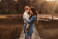 Maternity Photos in Charleston, SC -- Expectant mother poses for Maternity Portraits during Sunset on the Marsh Charleston, SC.