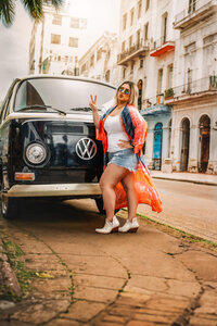 Allie Cline posing beside a vintage van during travels abroad