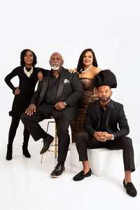 Family in all black formal attire posing for family portrait.