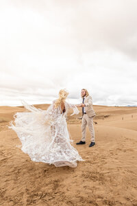 man and woman posing at Sand Dunes Elopement Utah by Savvy Shoots Photography