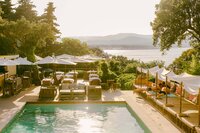 Pool terrace and shaded daybeds overlooking the bay at Bastide d'Antoine, Saint-Tropez
