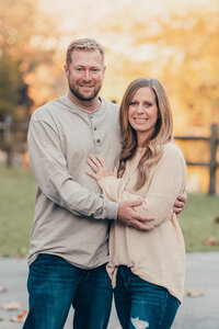Parents embracing closely outdoors during a Cleveland family photography session
