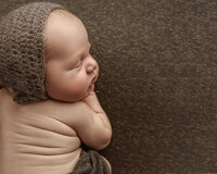 Sleeping newborn baby posed in a timeless studio portrait by a Baton Rouge newborn photographer
