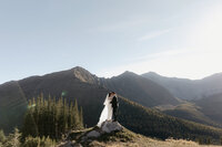 Couple dancing in a meadow in the mountains on their wedding day.