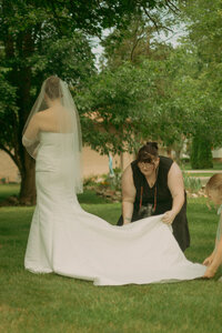 Photographer carefully arranging a flat-lay photo with wedding details