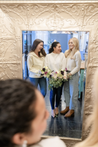 Three women standing in front of mirror at Maison Charlottesville - photo by Jo Mahoney