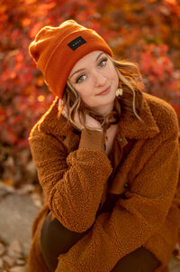 An Arrowhead High School senior sits on a bench surrounded by Fall color at Retzer Nature Center in Waukesha.