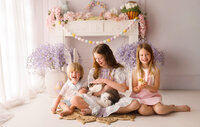 Siblings pet a live bunny and hold baby chics during Easter Mini Session at Holy City Babies Portrait Studio in Charleston, SC.