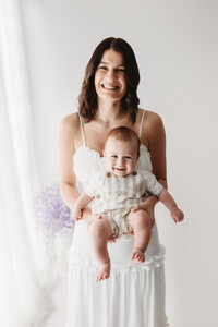 Charleston Mini Sessions - Mother embraces her baby during Mother's Day Mini Session at Holy City Babies in Charleston, SC.